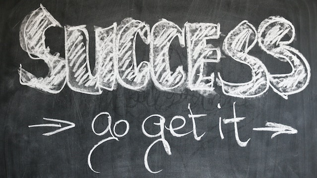 Words written in chalk say, “Success, go get it.”