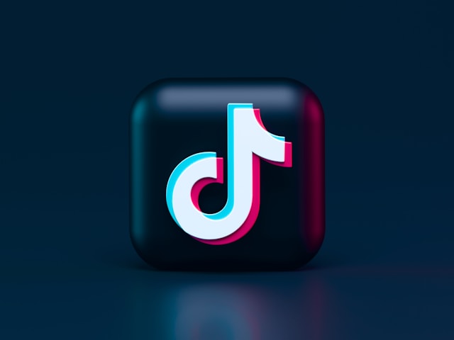 A black, 3D square with the TikTok logo in red and white.
