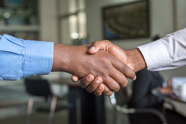 Two people shake hands to agree with each other’s terms. 
