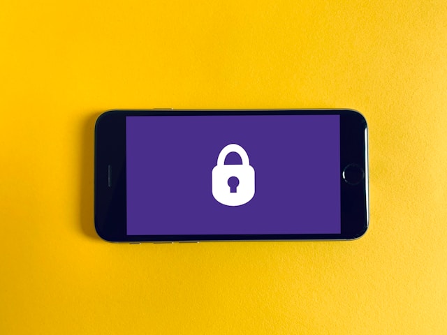 A phone screen displays a white padlock on a purple background.