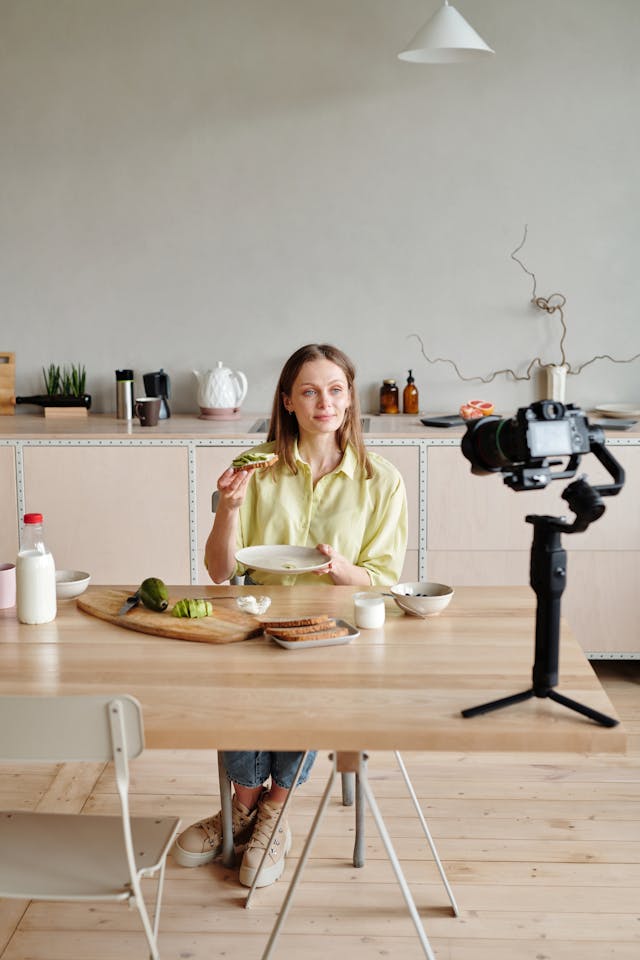 A woman records herself showing off a meal.
