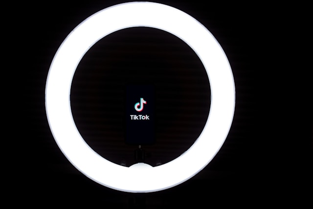 The TikTok logo inside a ring light.
