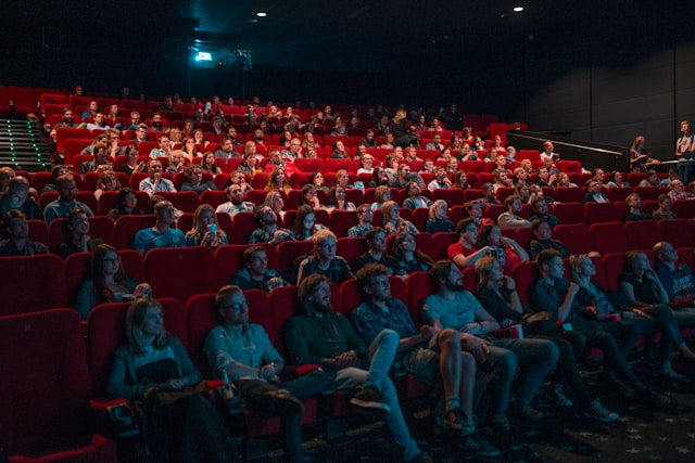 Viewers enjoy a movie inside a theater. 
