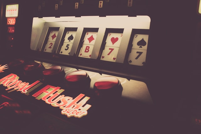 A slot machine reel displays random playing cards.
