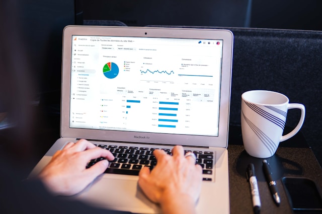 A person studies their social media analytics on their laptop. 