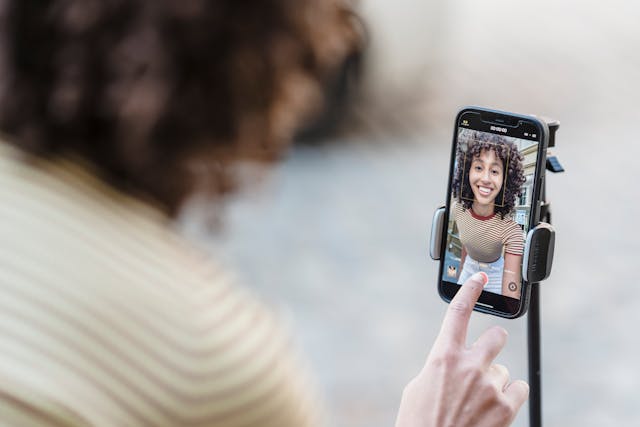 A woman hits record on a video.
