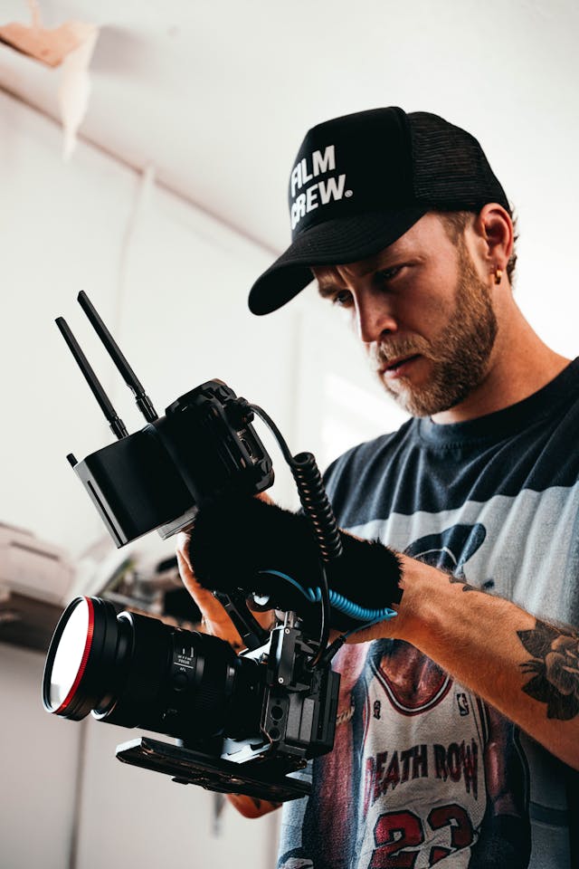 A man records a video with a large camera.
