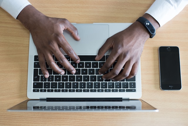 A person checks their email notifications on a laptop. 
