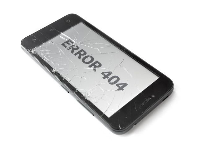 A phone with a broken screen displays an “Error 404” message. 
