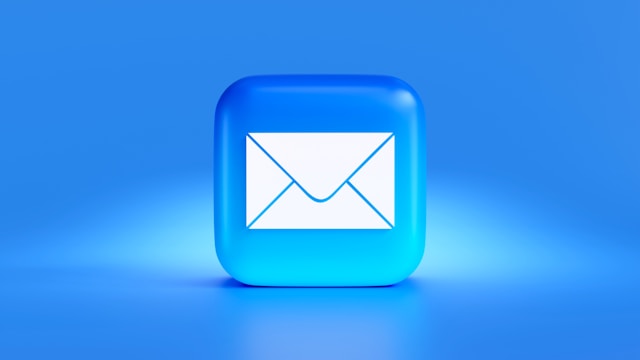 A blue square with a white envelope icon printed on it represents the universal sign for “email.”
