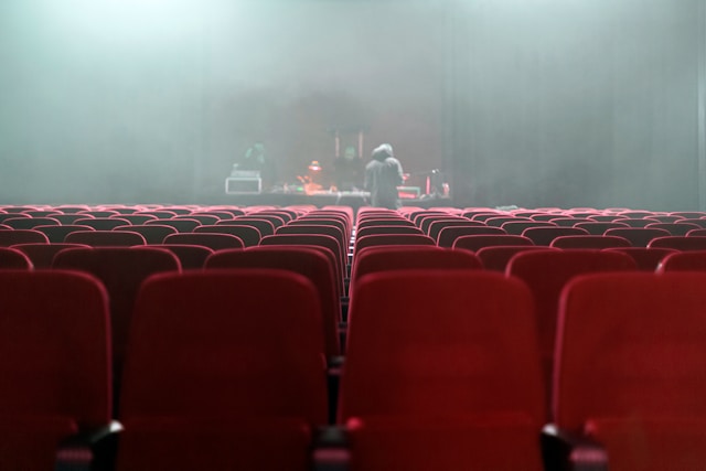 Rows of empty seats in a theater. 
