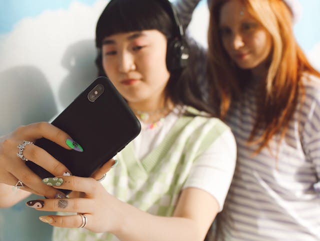 Two women take a selfie together.
