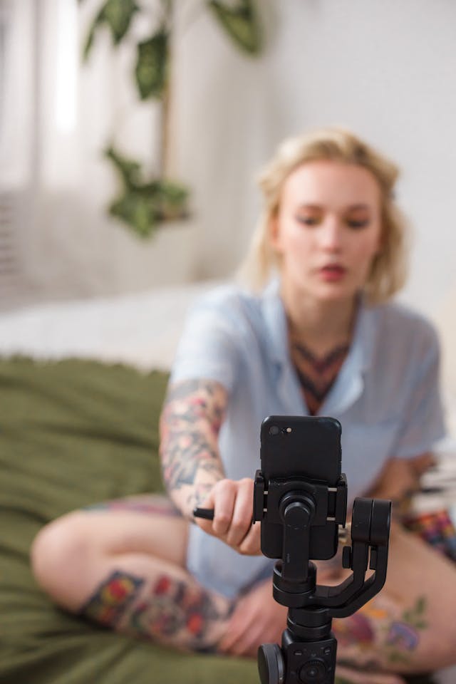 A woman taps the screen of her mounted cell phone.
