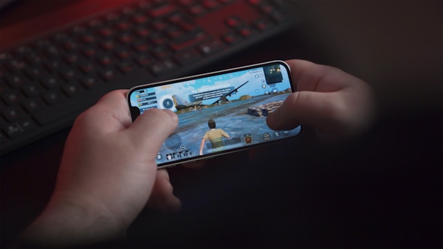 A person plays a video game on their smartphone. 
