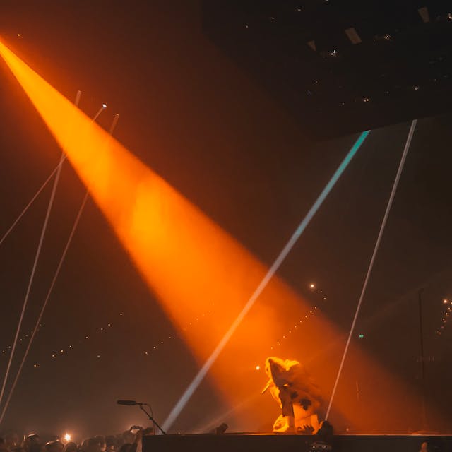 A spotlight shines down on a performer.
