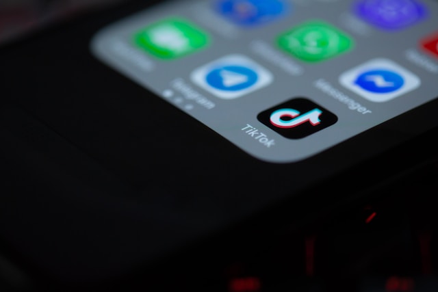 A mobile device shows several apps, including TikTok.