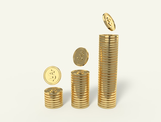 Three stacks of gold coins marked with the dollar sign. 
