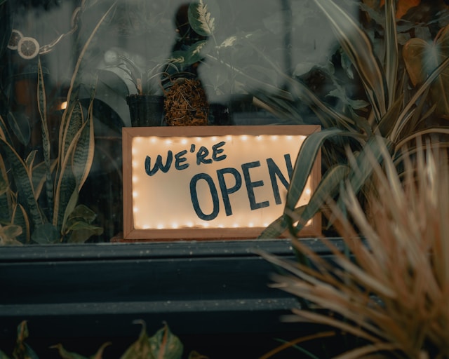 A sign in a store window says, “We’re open.”