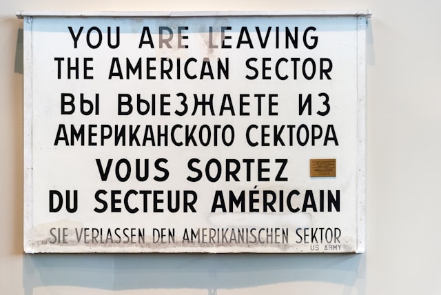 A sign that reads, “You are leaving the American sector,” translated into various languages.