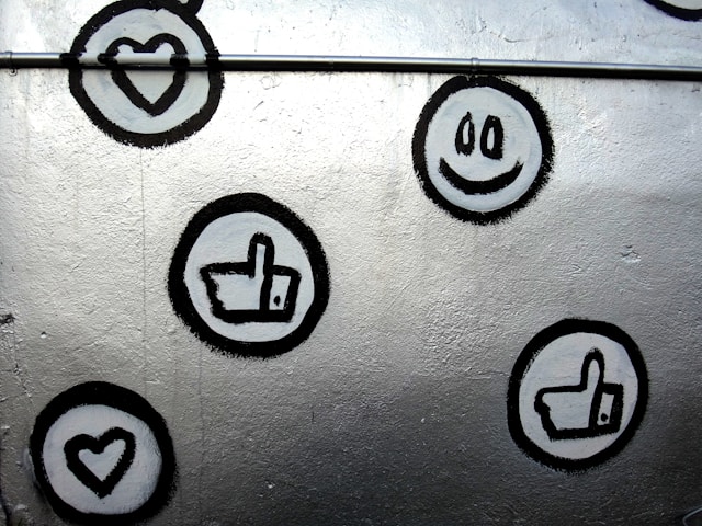 Several hand-drawn social media engagement icons on a wall.
