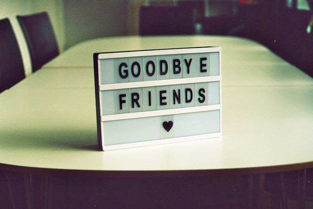 Letter tiles on a table say, “Goodbye Friends.”
