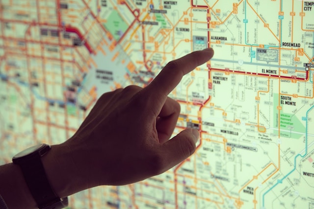 A person points at a location on a street map.
