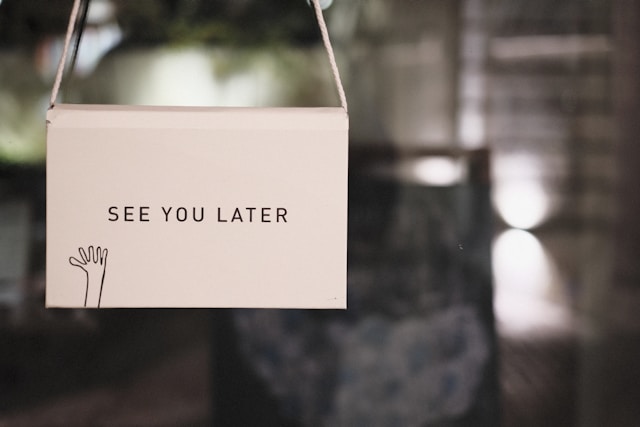 A sign on a glass door reads, “See you later.”
