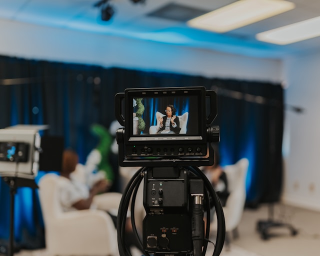 A video camera records two women hosting a TikTok LIVE stream. 
