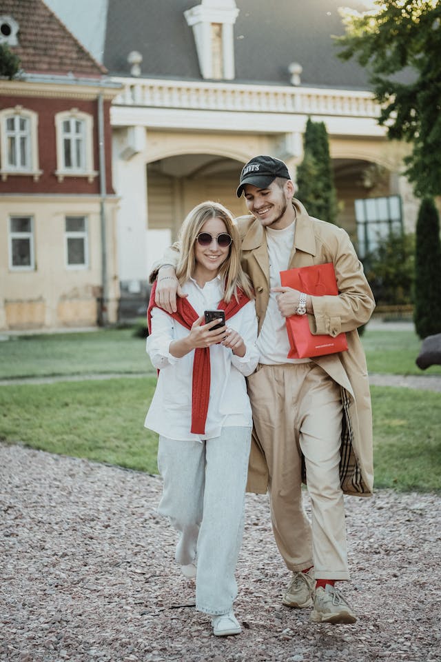 A couple with a woman looking at a phone.
