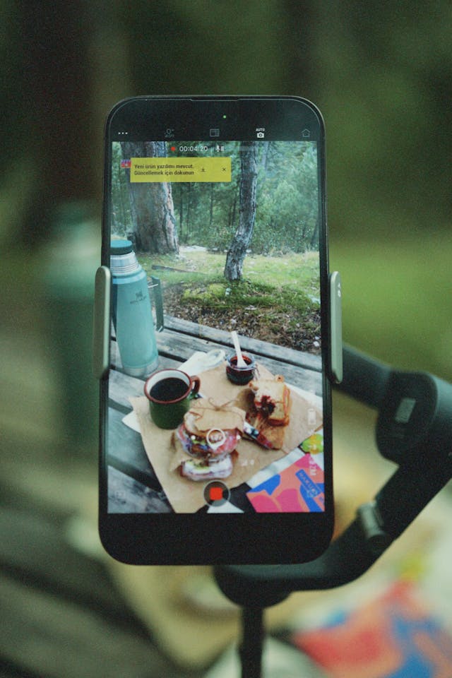 A propped-up camera records someone's breakfast by a window.
