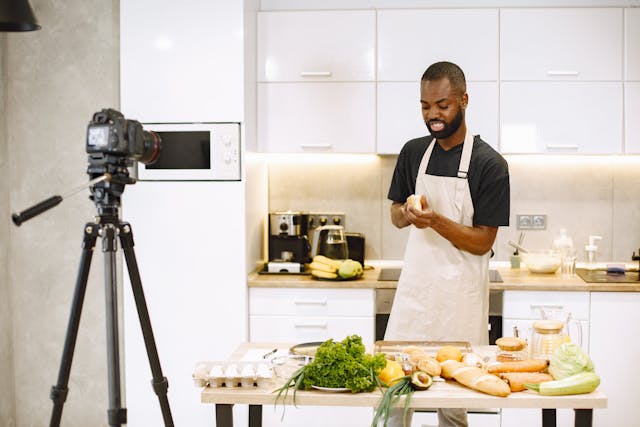 A man records himself preparing a meal.
