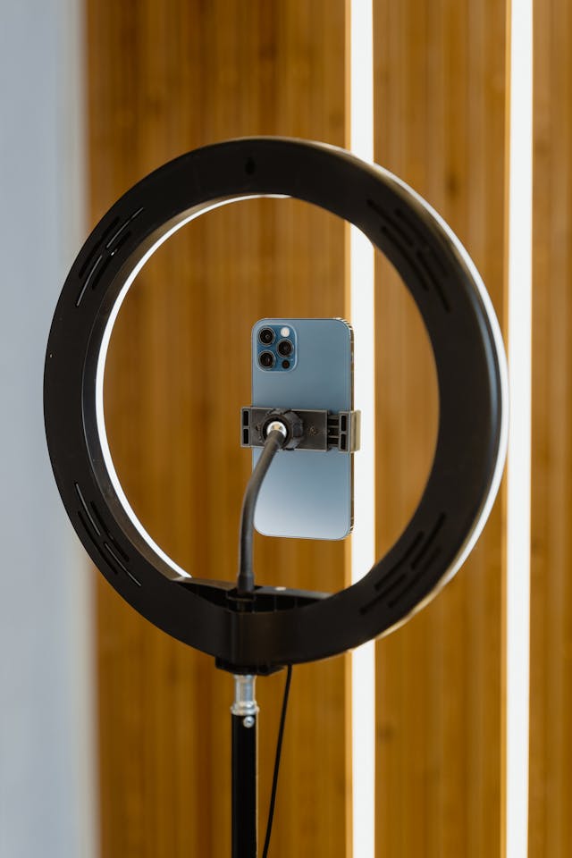 A cell phone mounted in front of a ring light.
