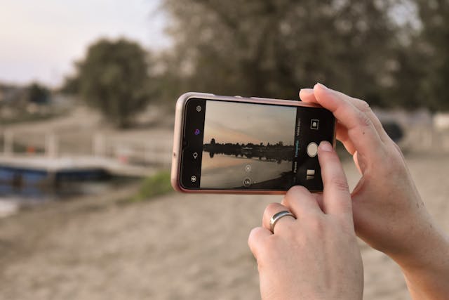 A person takes a photo of the scenery ahead.
