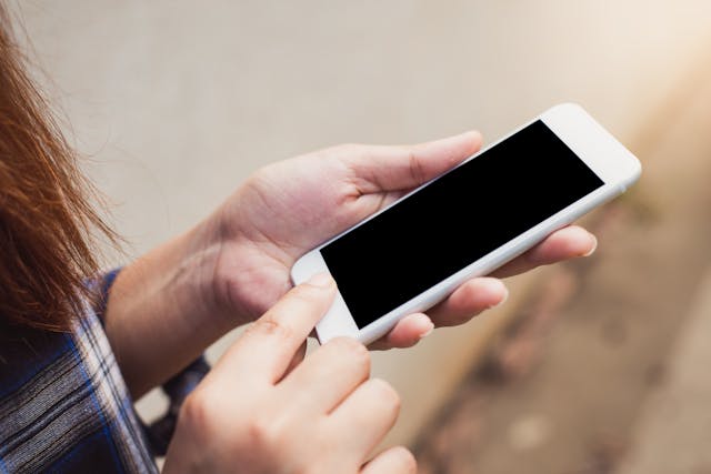 A person holds a cell phone.
