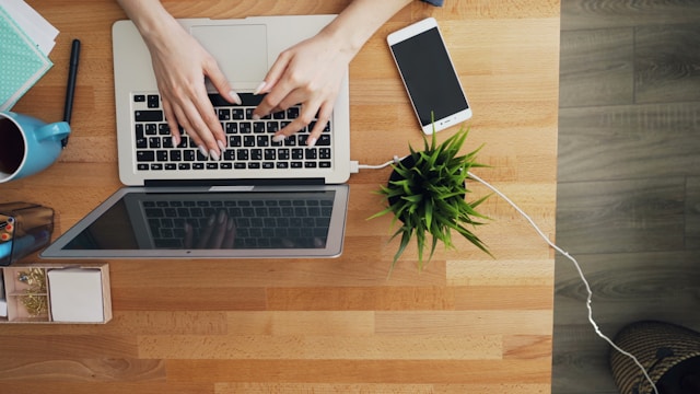 A person uses a laptop to browse TikTok without the app.