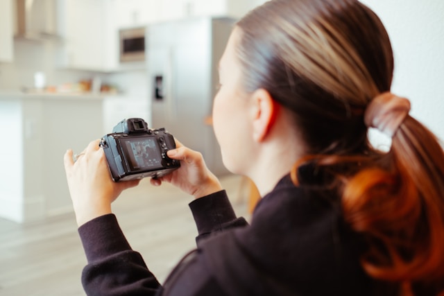 A woman browses through video files in her digital camera. 
