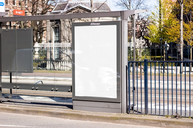 A blank billboard at a bus stop. 
