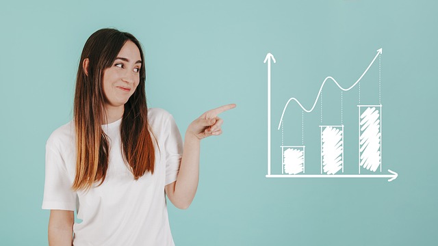 A person points to a bar graph indicating growth.