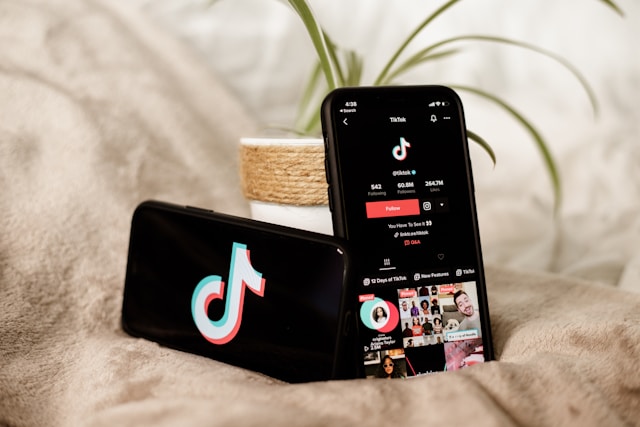 Two mobile devices show the TikTok logo and TikTok’s profile on TikTok.