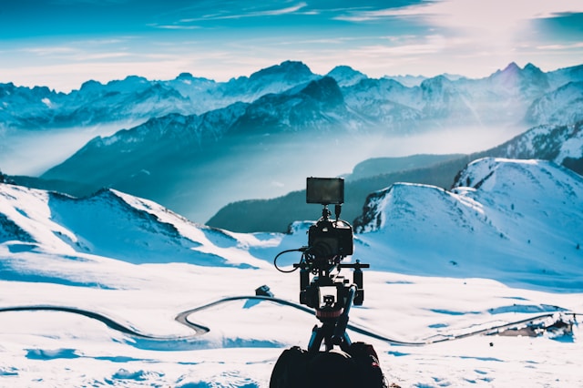 A DSLR camera setup captures a snowy landscape. 
