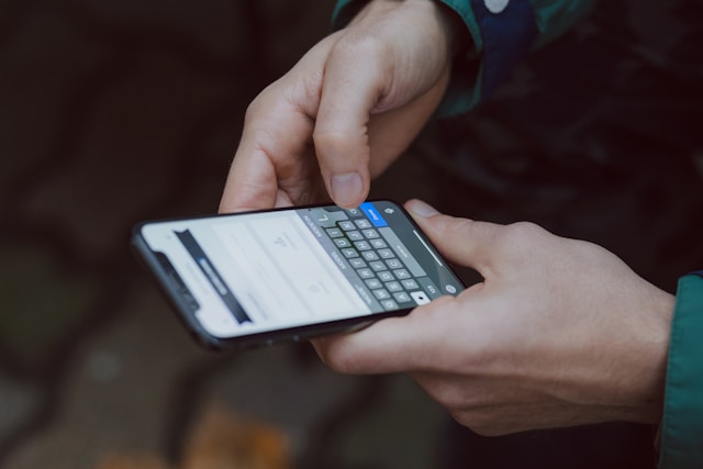 A person types a comment on a TikTok video using their phone. 
