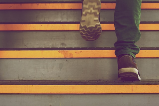 A person climbing the stairs. 
