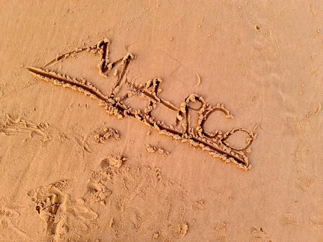 The name “Marco” is traced in the sand on a beach. 
