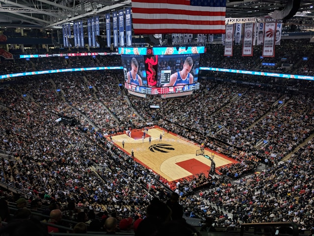 Spectators fill all the seats in a giant stadium. 

