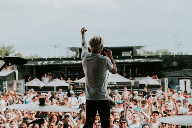 A performer sings in front of a live audience. 
