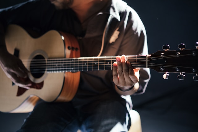 A musician plays the guitar. 
