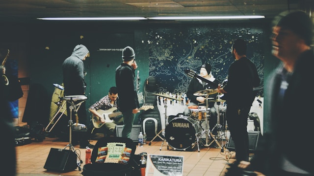 A band performs at a train station. 
