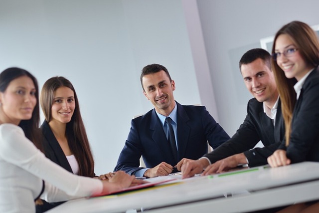 A business team poses for a photo after a meeting.
