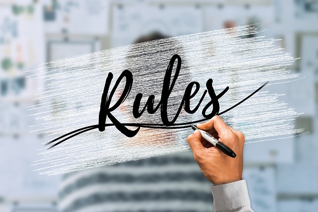 A person writes "Rules" on a transparent surface.
