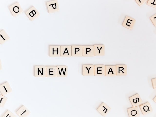 Scrabble tiles spell the words “Happy New Year.”
